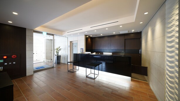 A modern kitchen with dark cabinetry, a central island, and recessed lighting. - Meitetsu Inn Nagoya Sakuradori (Nagoya)