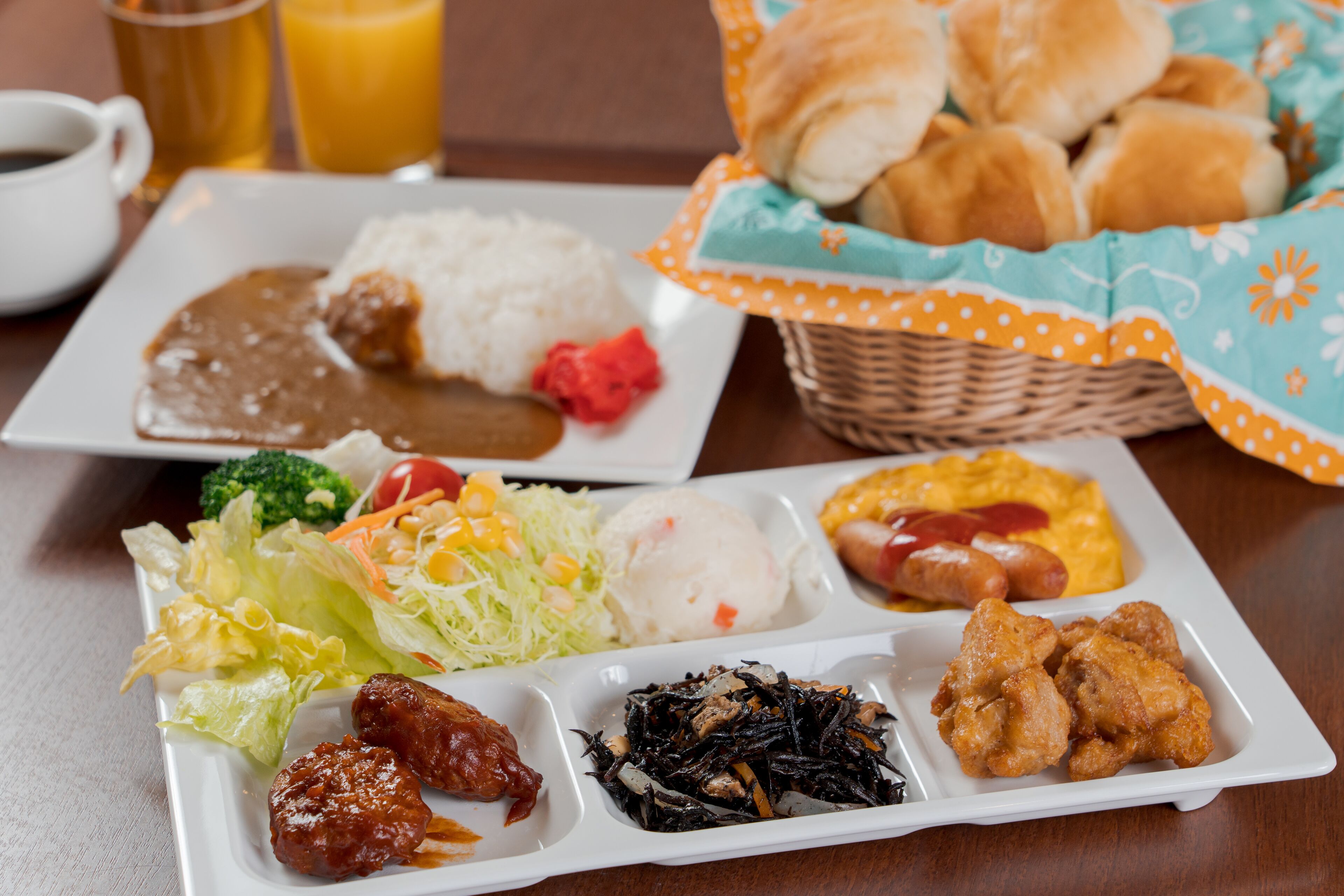 A meal with various dishes including rice, meatballs, and vegetables.