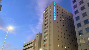 A multi-story hotel building with a prominent sign indicating it is a hotel.