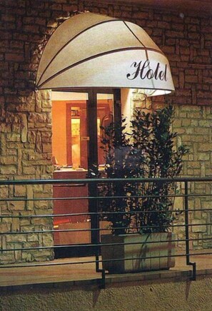 A hotel entrance with a sign that reads "Hotel" under a canopy. - I Cugini (Castelfidardo)
