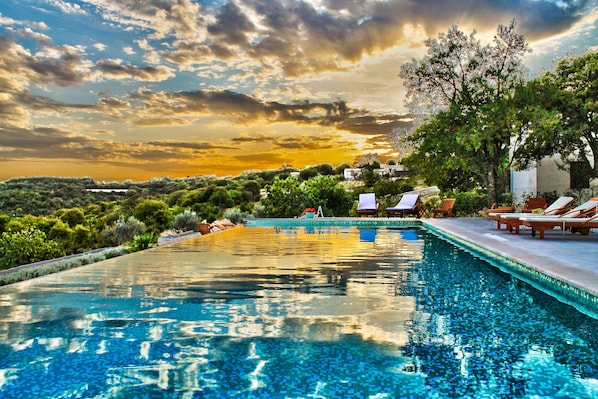 Seasonal outdoor pool, open 8:00 AM to 7:00 PM, pool umbrellas