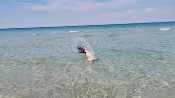 A clear view of the ocean with a person in the water.
