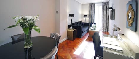 A modern living room with a dining table, a sofa, and a coffee table.