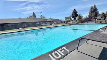 A swimming pool with a lifeguard chair and a '10FT' depth marking.