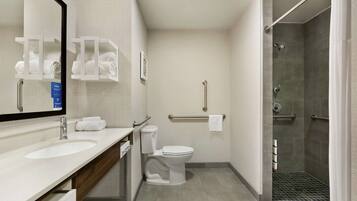 A modern bathroom with a sink, toilet, and shower.