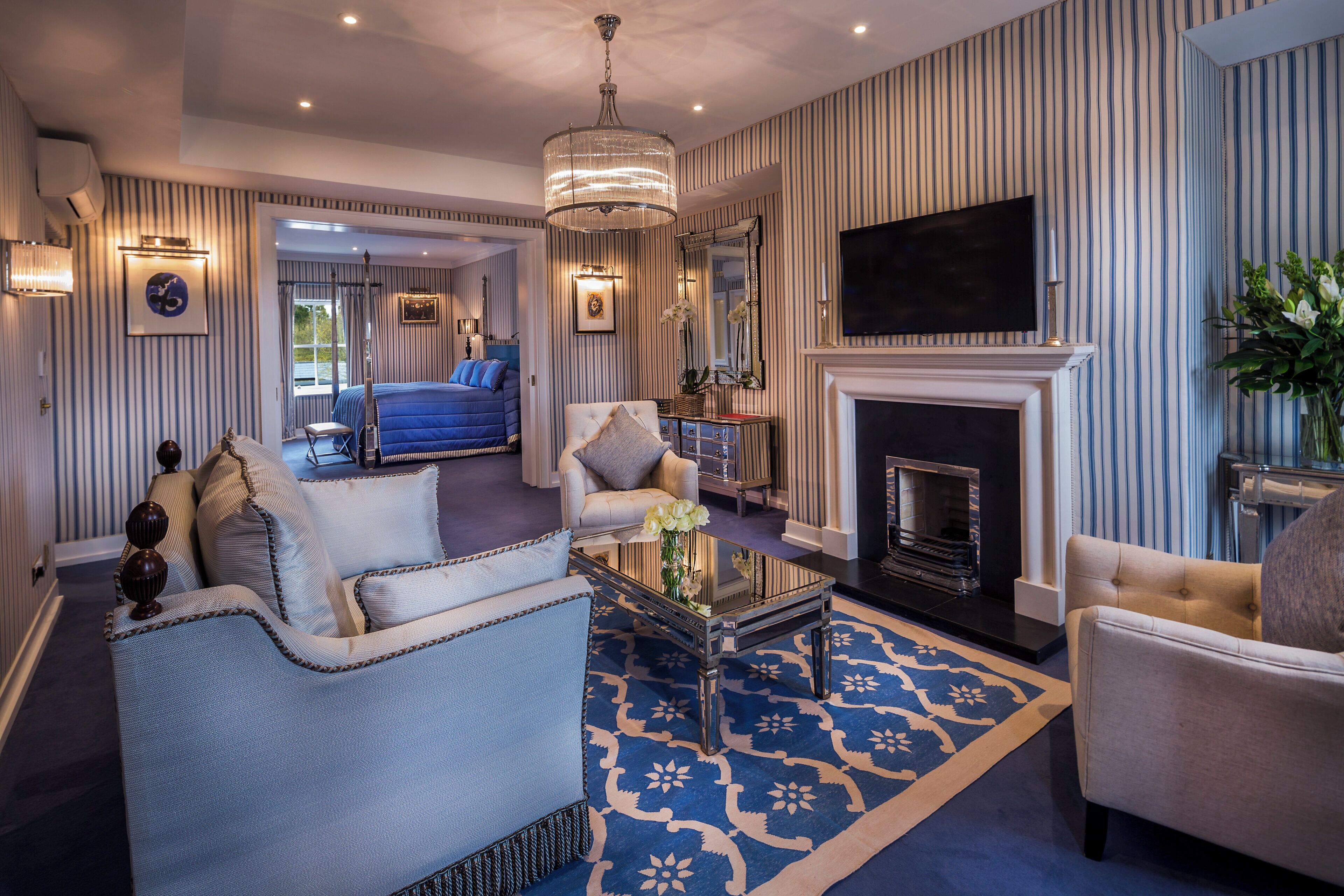A spacious living room with a fireplace, a television, and a large window.