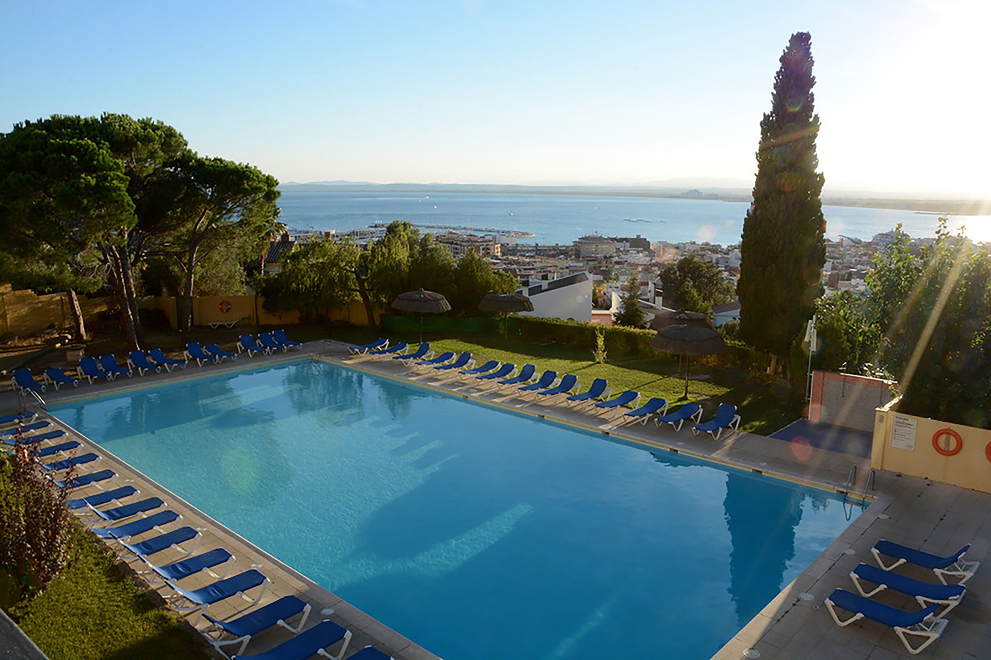 Outdoor pool, open 10:00 AM to 8:00 PM, pool umbrellas, pool loungers