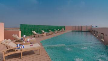Indoor pool, open 7:00 AM to 7:00 PM, pool umbrellas, pool loungers