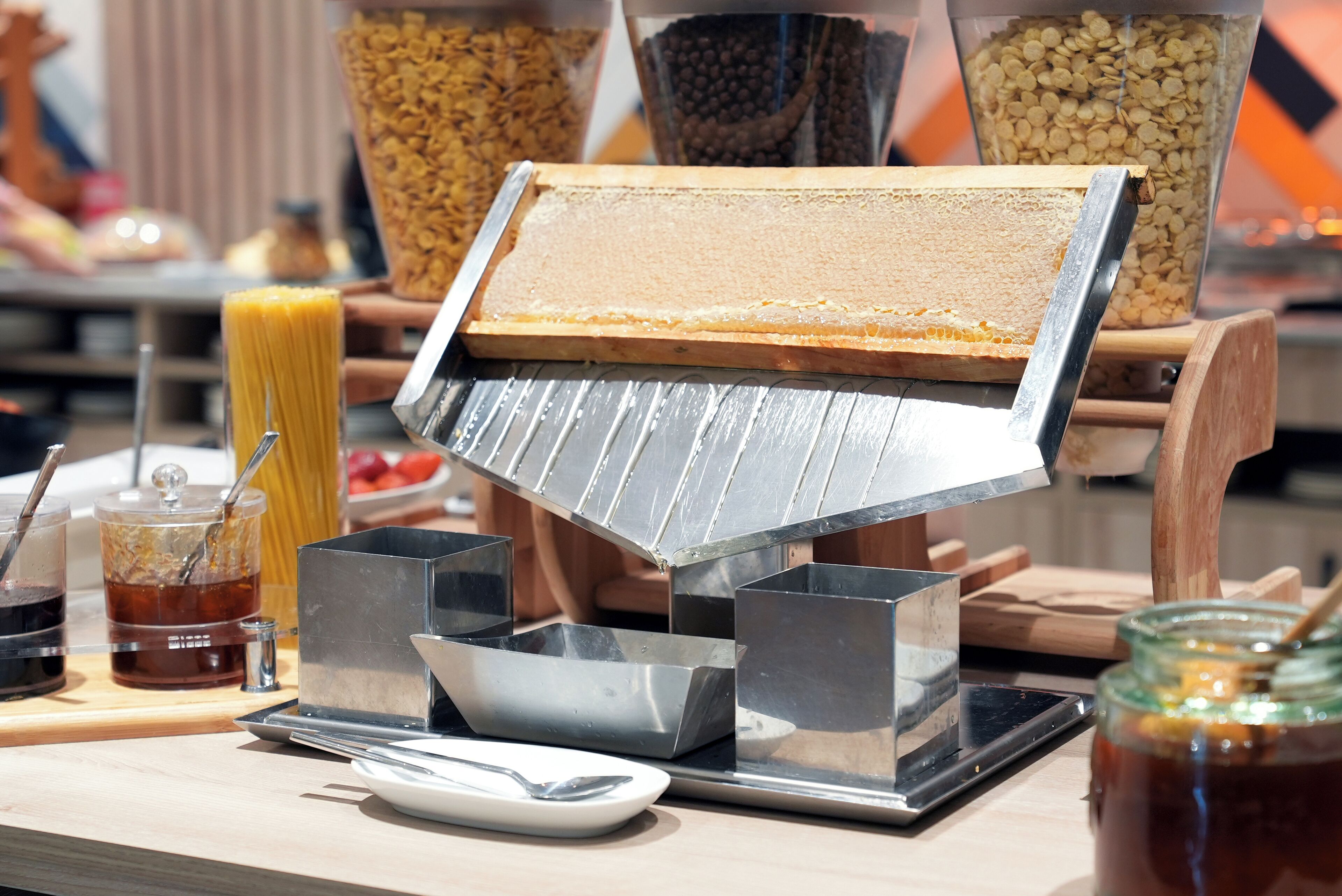 A buffet setup with various food items and utensils.