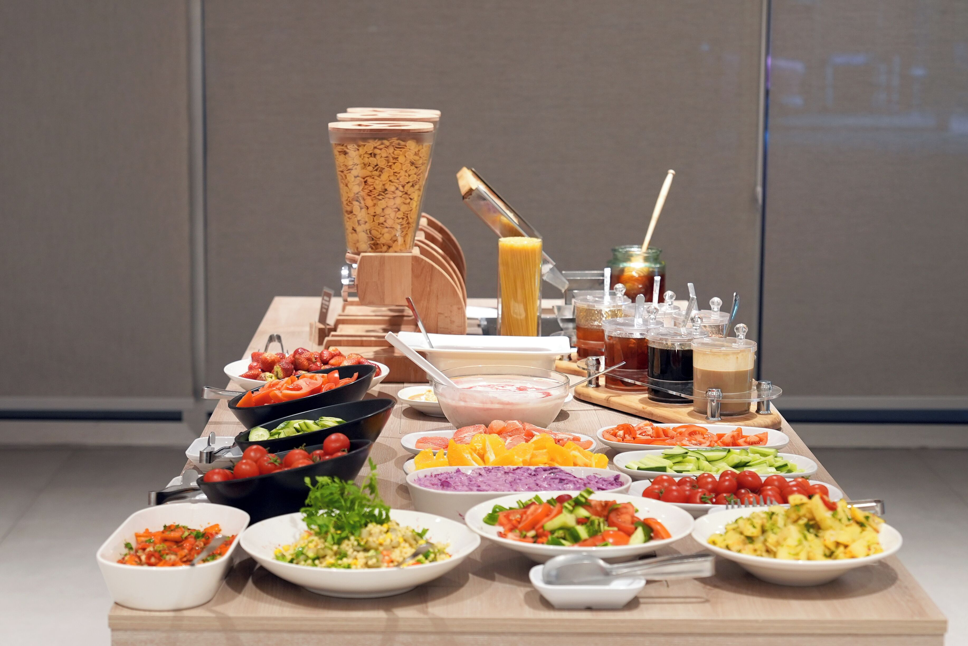 A buffet table with various food items and beverages.