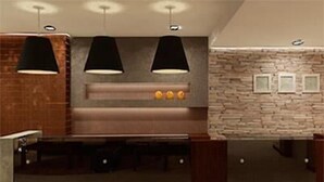 A modern kitchen with a stone backsplash, pendant lights, and a built-in stove. - Amerian Salta Hotel (Salta)