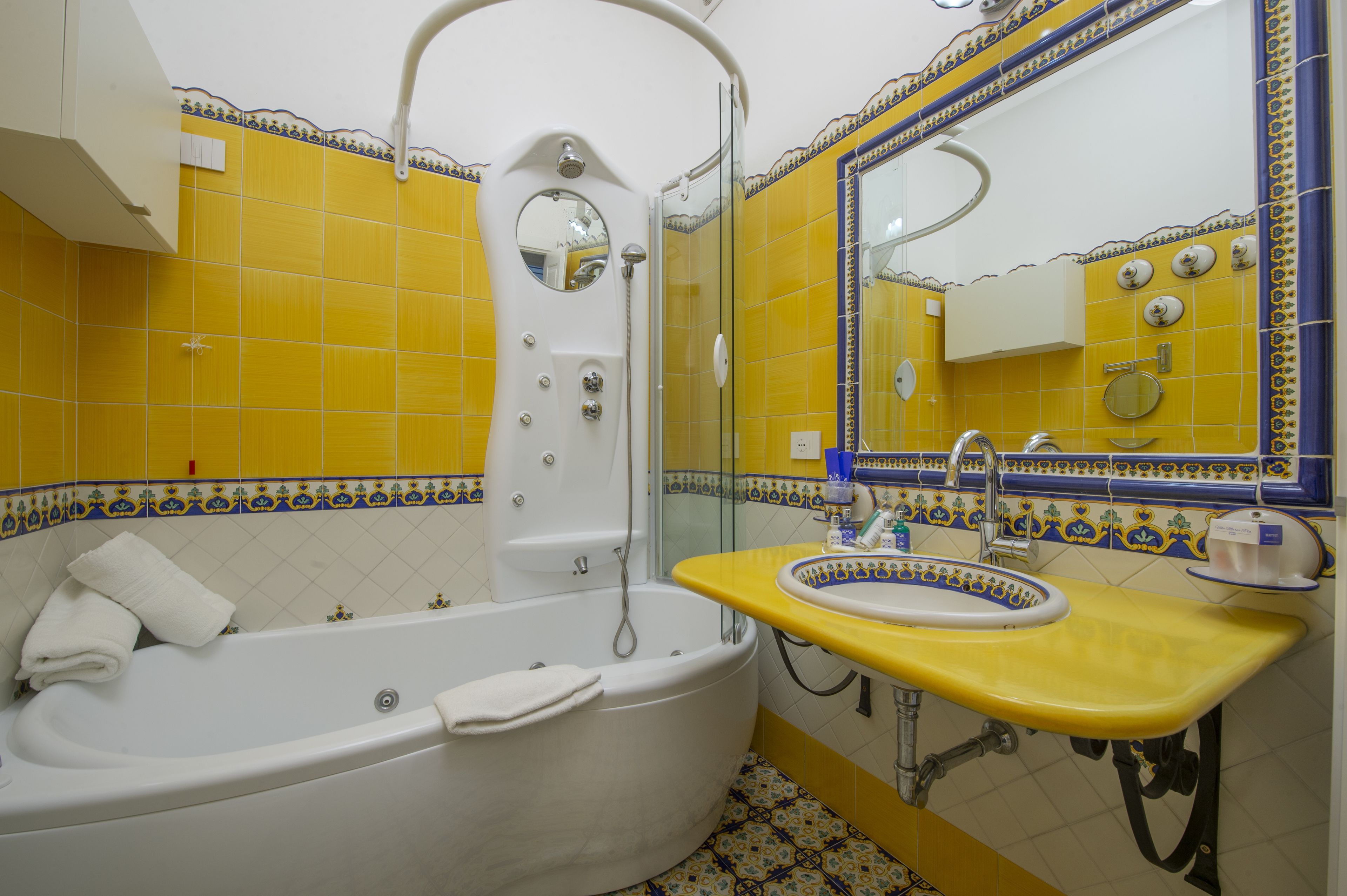 A bathroom with a bathtub, a sink, and a mirror.