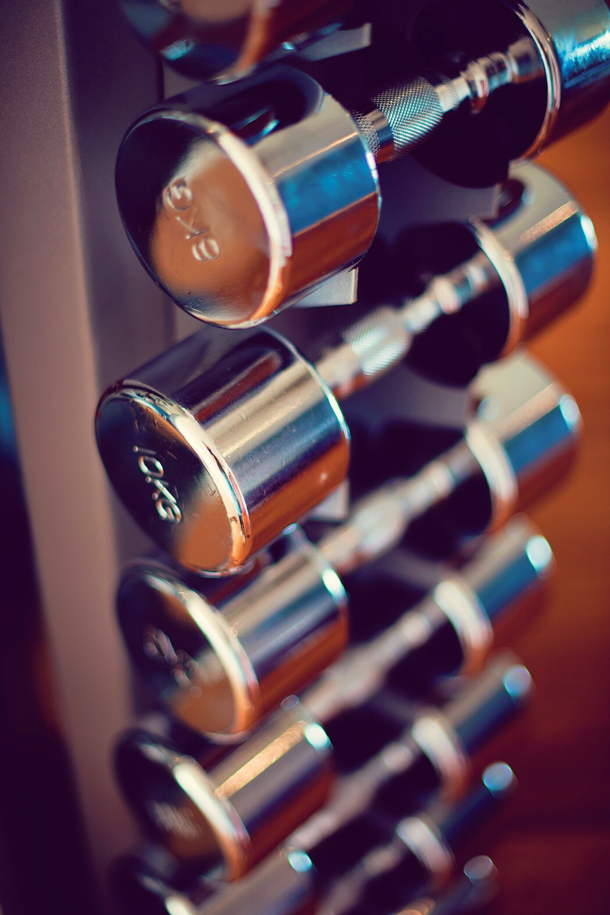 A close-up of metallic cylindrical objects with a reflective surface, likely part of a mechanical or industrial setting.