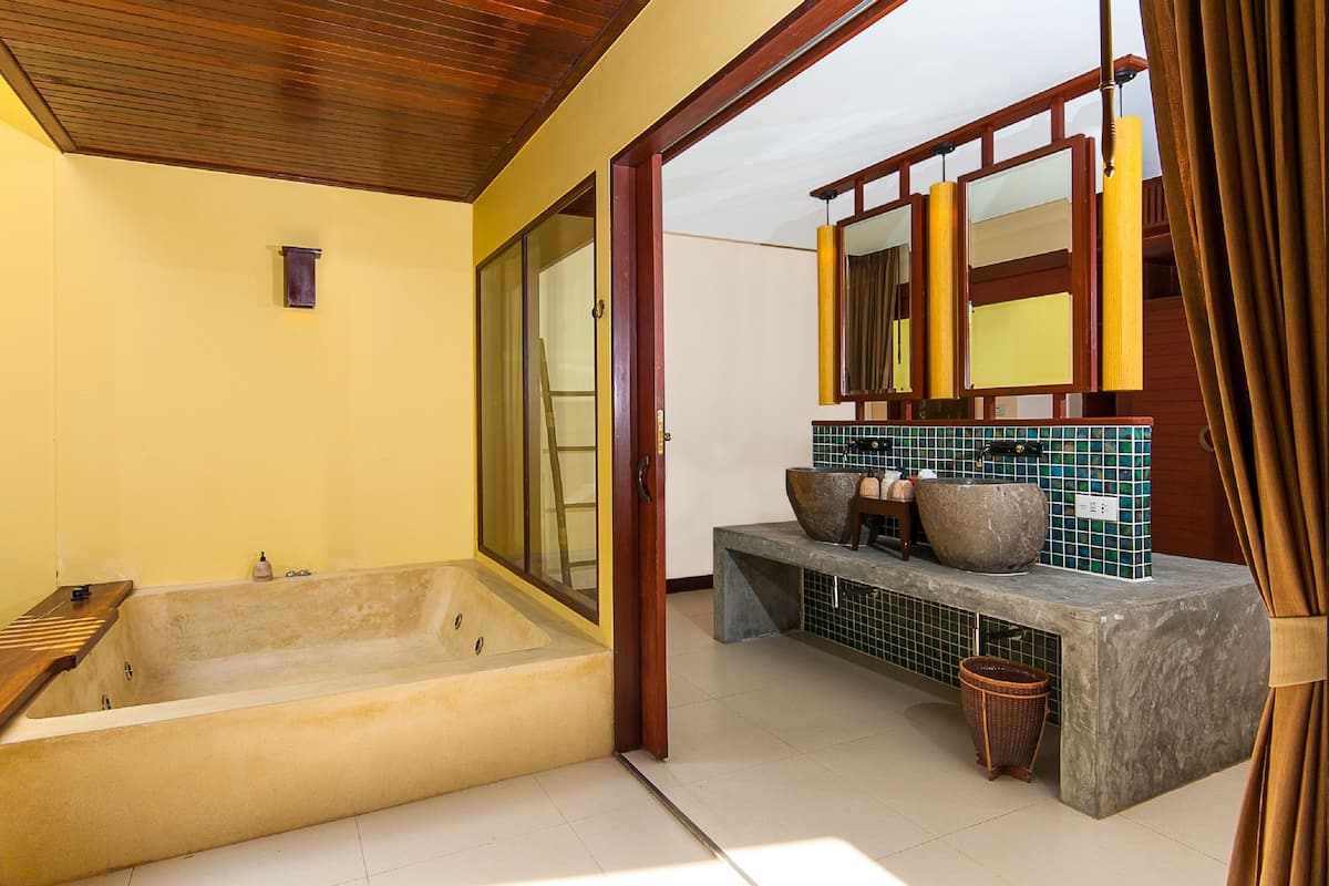 family room | bathroom | separate bathtub and shower, rainfall showerhead, designer toiletries