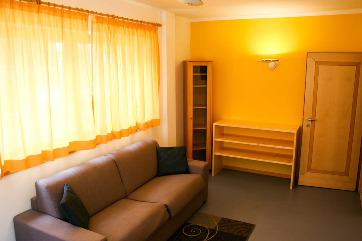 suite | living room | 26-inch flat-screen tv with satellite channels, tv, heated floors