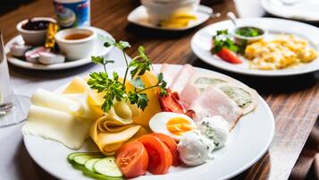 A plate of food with various items including eggs, cheese, and vegetables.