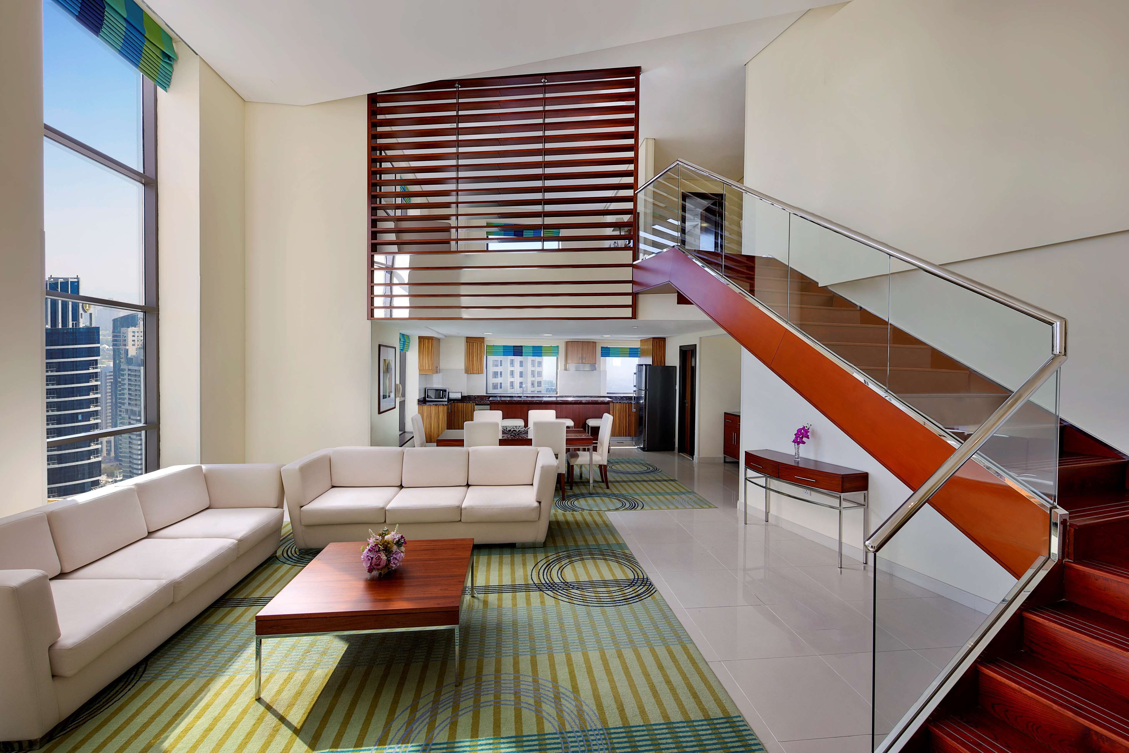 king duplex suite | living area | 55-inch flat-screen tv with cable channels, tv, dvd player