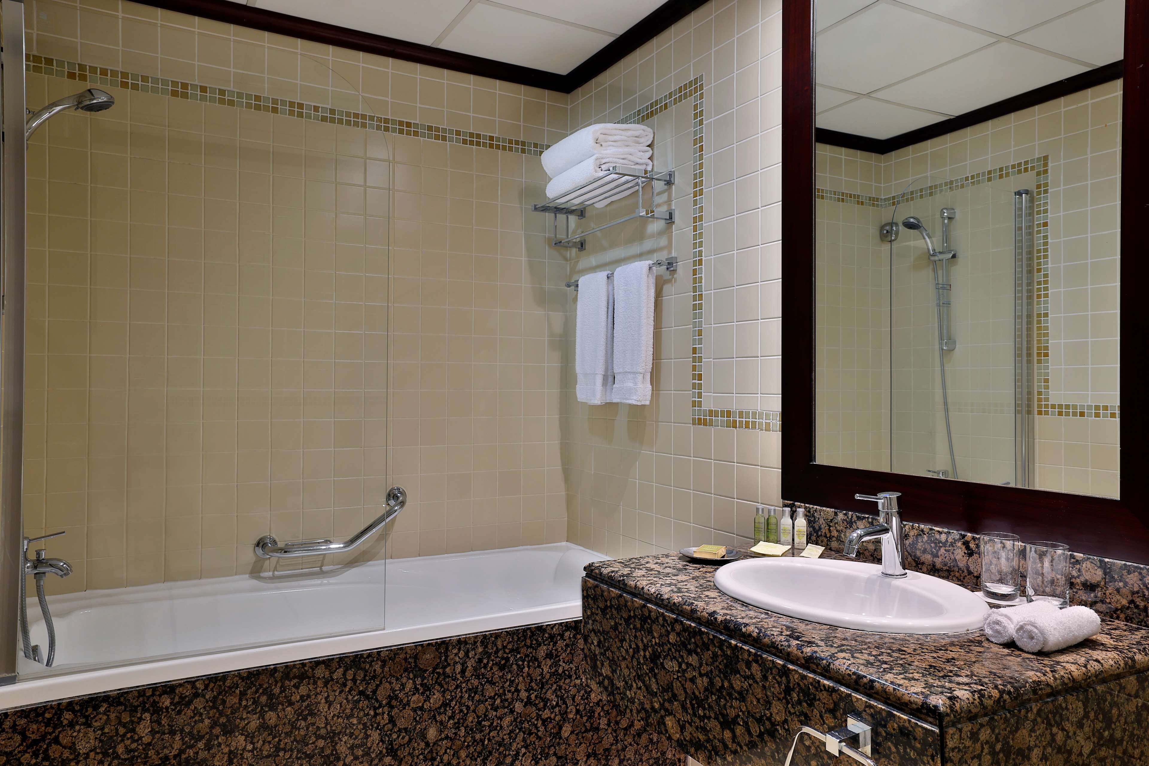 A bathroom with a bathtub, a sink, and a shower.