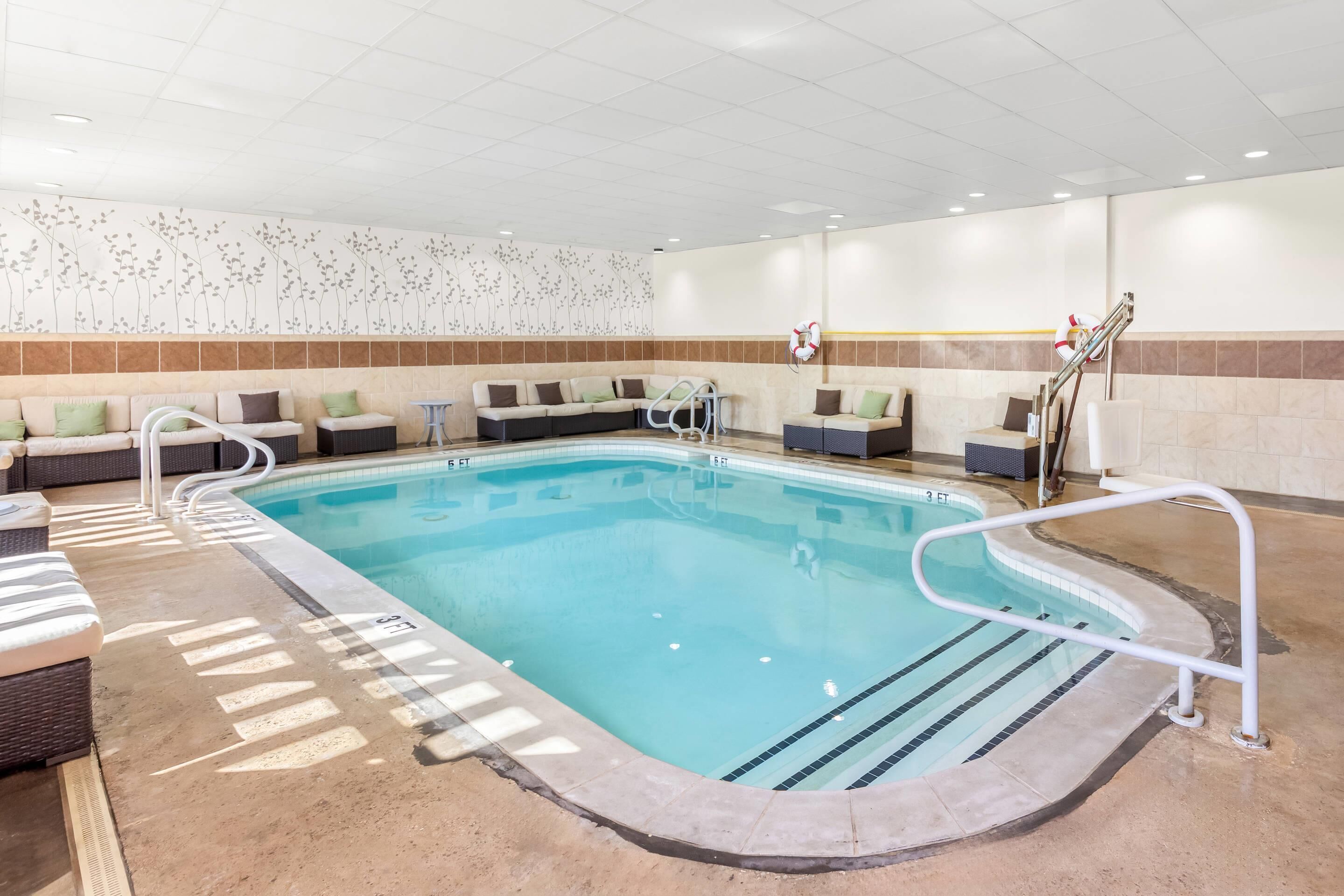 A pool area with lounge seating and a lifeguard station.