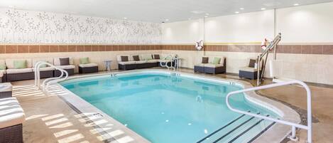 A pool area with lounge seating and a lifeguard station.