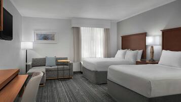 Premium bedding, desk, laptop workspace, blackout drapes