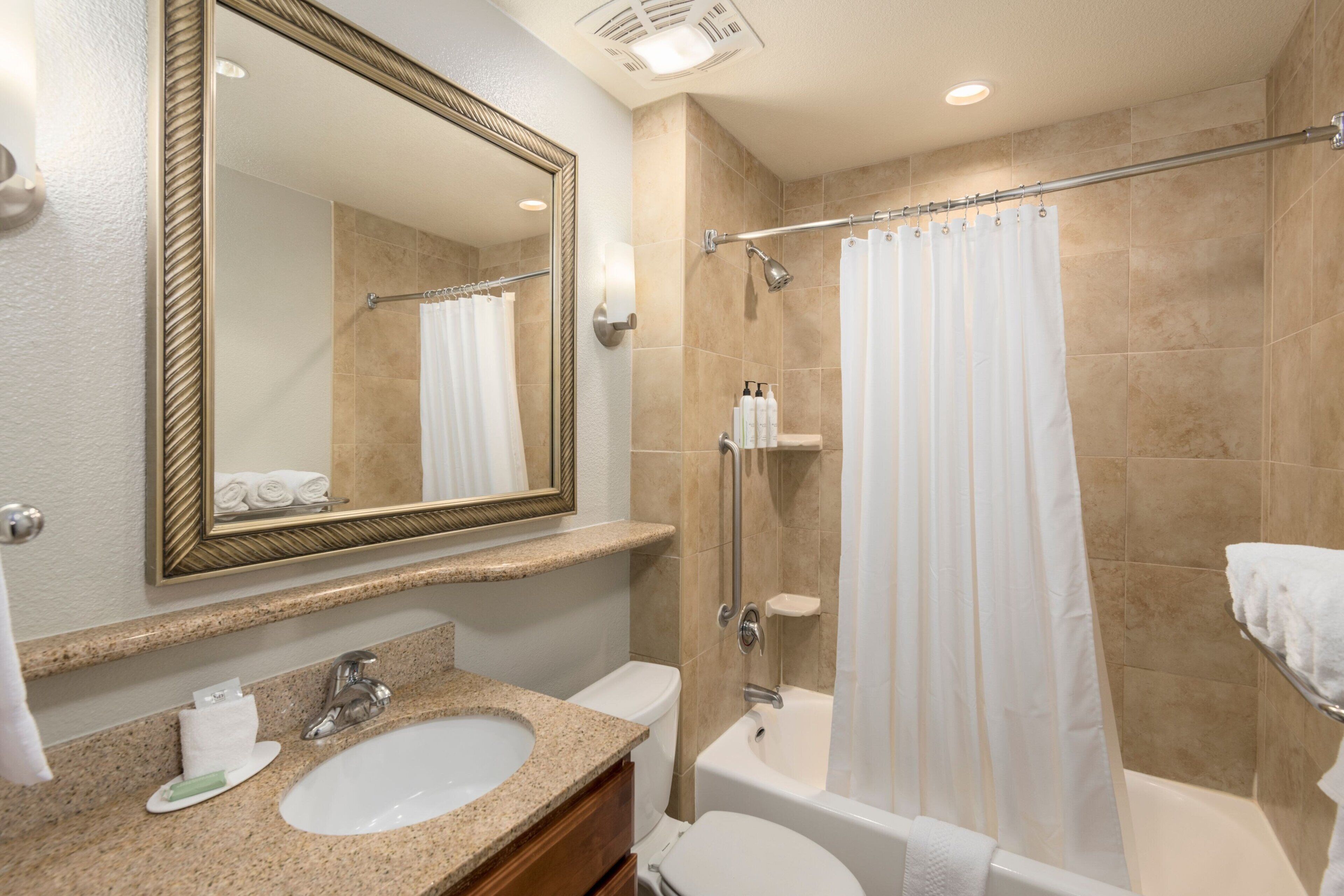 A bathroom with a sink, toilet, and bathtub.