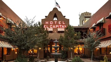 A hotel with a prominent sign reading 'HOTEL EL CAPITAN' and a flag above it.