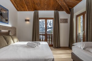 Superior Triple Room | Minibar, in-room safe, desk, blackout drapes