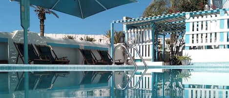 Seasonal outdoor pool, open 10:00 AM to 6:00 PM, pool umbrellas