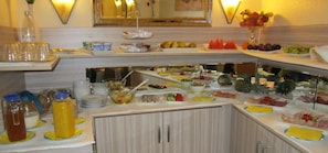 A buffet setup with various food items and beverages.