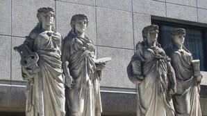 Eine Reihe klassischer Statuen vor einem Gebäude.