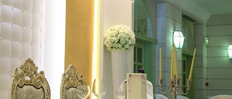 A table set with fine china, a candelabra, and a floral arrangement.
