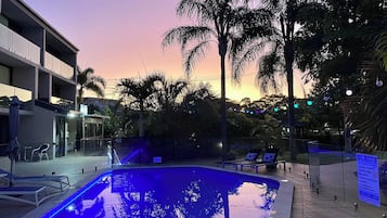 Outdoor pool, a heated pool, pool umbrellas, pool loungers