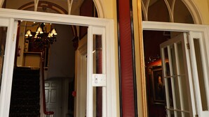 An interior with a chandelier, arched doorways, and a staircase. - Regency Hotel (Brighton)
