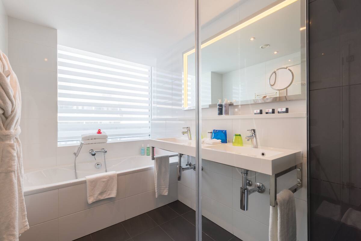 standard twin room | bathroom | shower, eco-friendly toiletries, hair dryer, towels