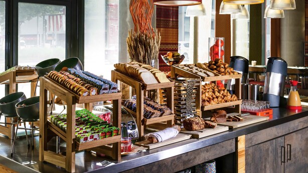 A buffet setup with various food items and a coffee station. - ibis Styles Lyon Centre - Gare Part Dieu Hotel (Lyon)