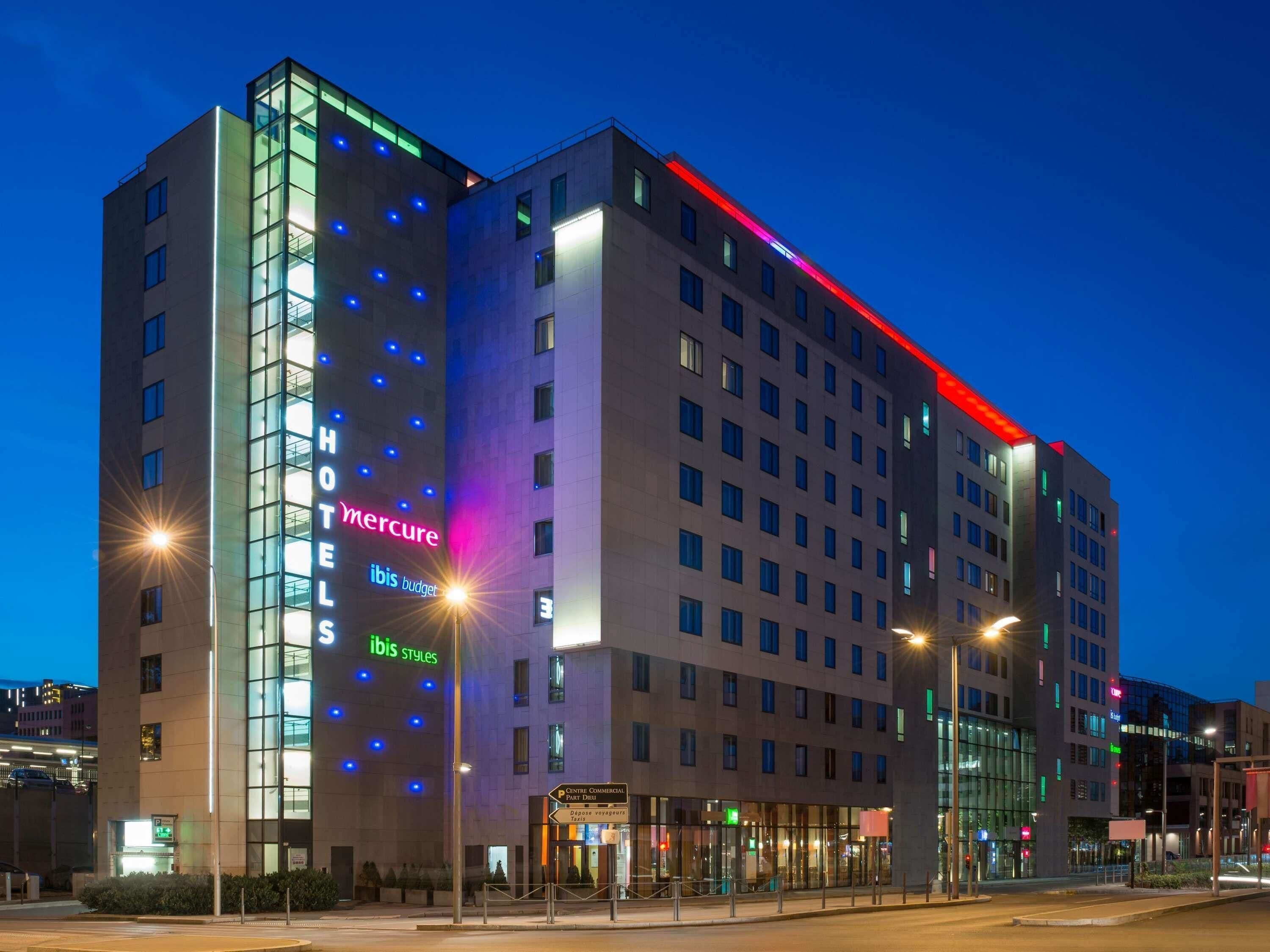 A multi-story hotel with illuminated signage for 'Mercure' and 'Ibis Styles' brands.
