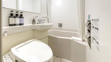 Un baño moderno con inodoro, lavamanos y bañera.