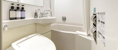 A modern bathroom with a toilet, sink, and bathtub.