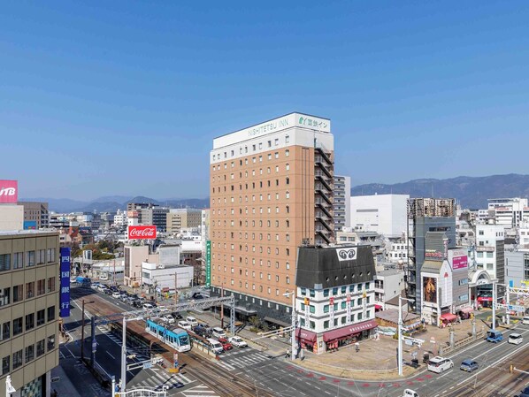 A multi-story building with a prominent sign for NISHITETSU INN.