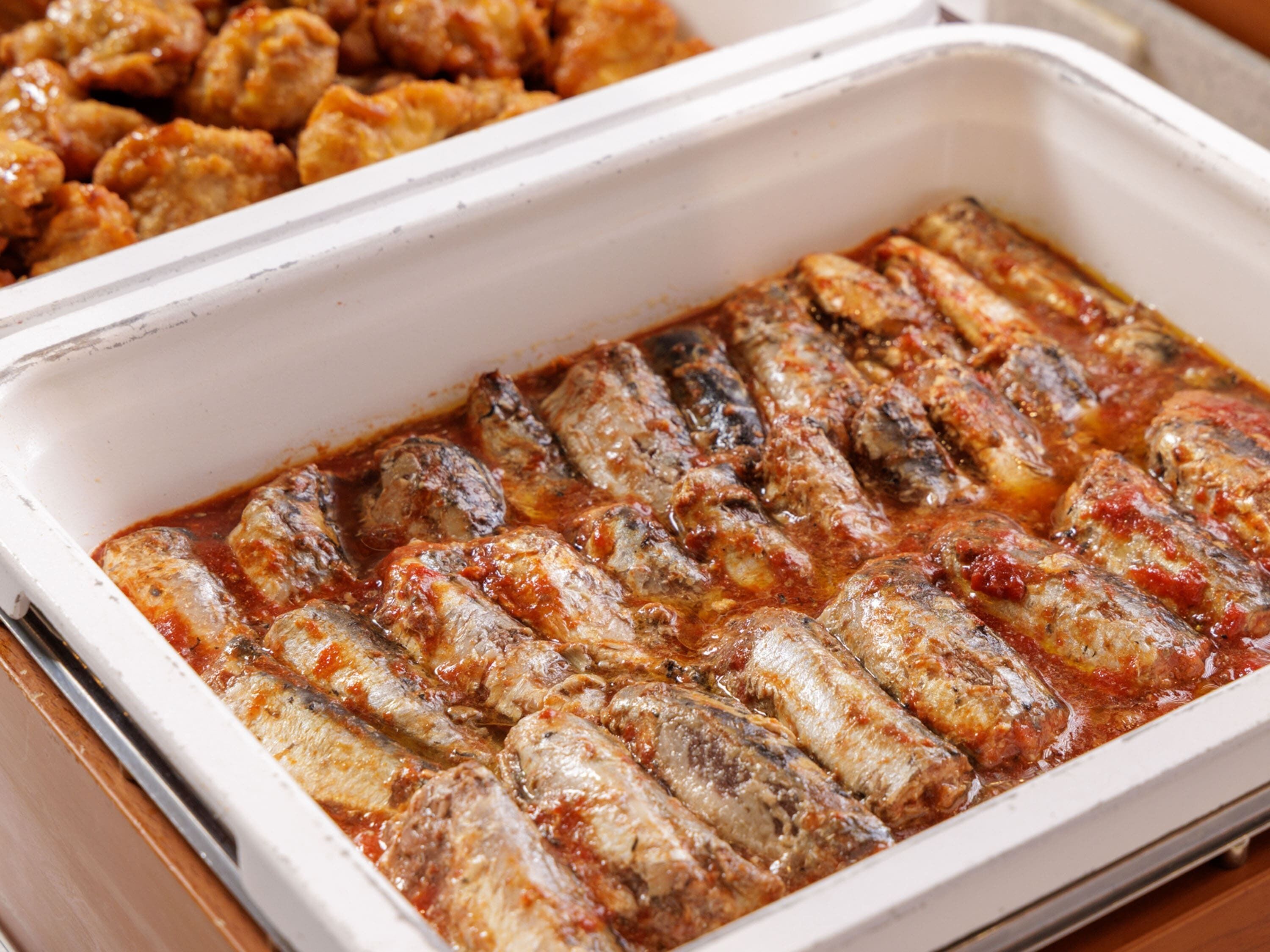 A tray of stuffed fish in tomato sauce.