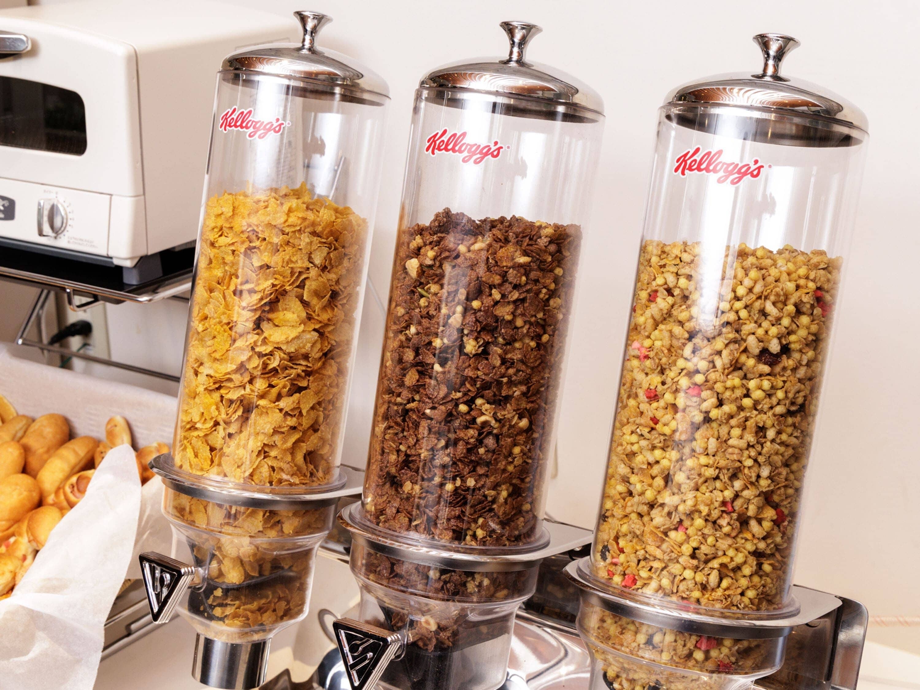 Three glass containers with different cereal brands.