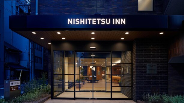The exterior of Nishi-Tetsu Inn with a modern design, featuring a glass entrance and a sign above the doors. - Nishitetsu Inn Nihonbashi (Tokyo)
