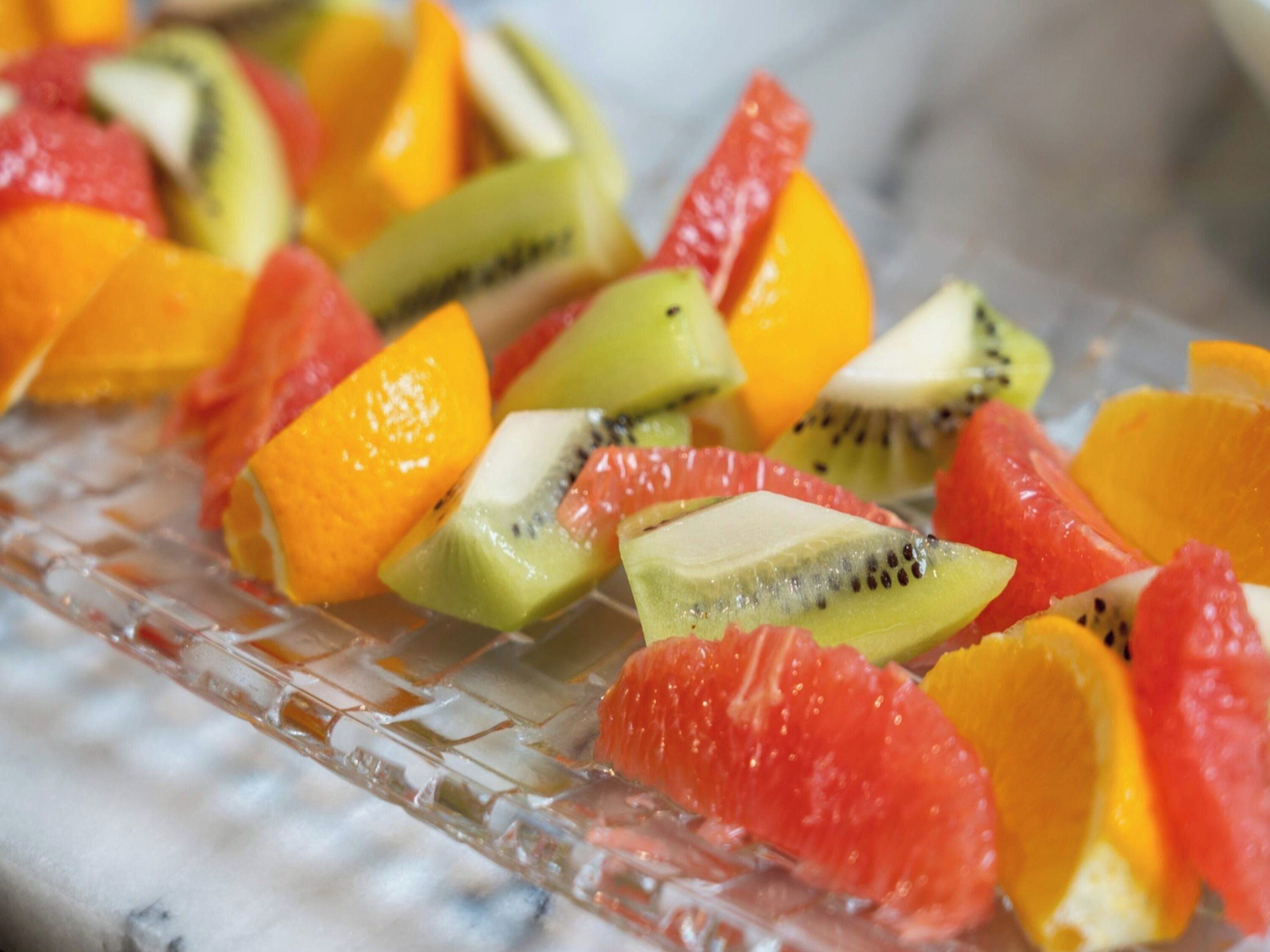 A glass dish with various fruit slices.
