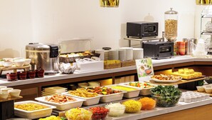 A buffet with various food items and a television. - Nishitetsu Inn Nihonbashi (Tokyo)