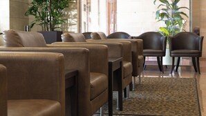 A seating area with leather chairs and a large potted plant. - Nishitetsu Inn Tenjin (Fukuoka)