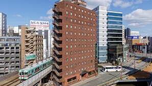 A multi-story building with a brick facade and multiple balconies. - Nishitetsu Inn Tenjin (Fukuoka)