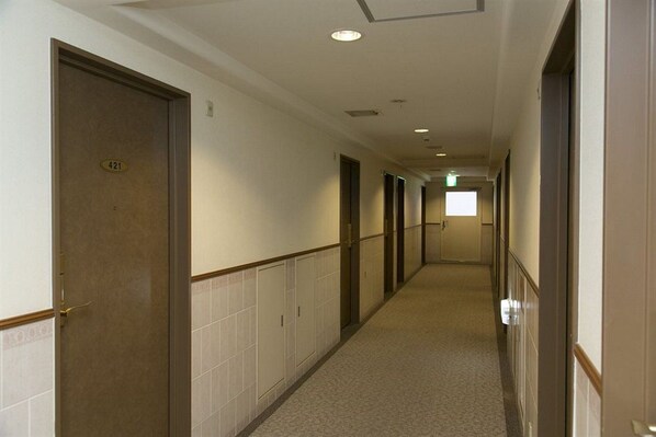 A hotel corridor with doors numbered 421, 422, and 423, leading to rooms. - Nishitetsu Inn Shinsaibashi (Osaka)