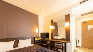 A hotel room with a large bed, a desk with a computer, a TV, and a mirror. - Nishitetsu Inn Shinsaibashi (Osaka)