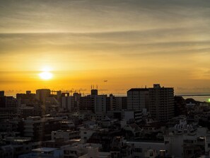 A cityscape at sunset with buildings silhouetted against the sky. - Nishitetsu Resort Inn Naha (Naha)